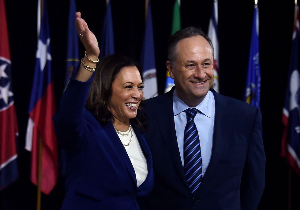 Kamala Harris and her husband, Douglas Emhoff, pose on stage after the first Biden-Harris press conference in Wilmington, Delaware, on August 12, 2020