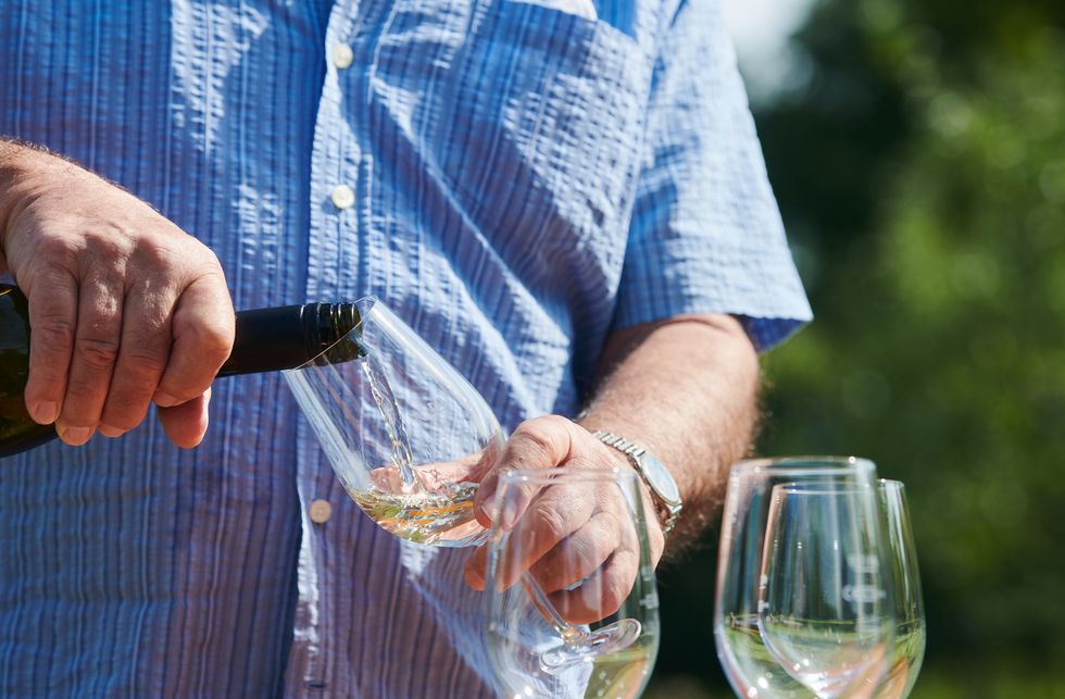 13 september 2020, brandenburg, potsdam a man pours wine for his guests and himself the park of the villa jacobs invites you to the wine festival in potsdam today summery temperatures have returned to the weekend photo annette riedldpa photo by annette riedlpicture alliance via getty images