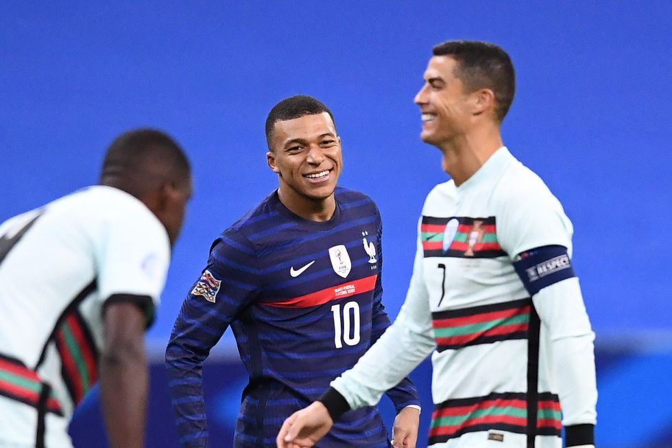 frances forward kylian mbappe c shares a laugh with portugals forward cristiano ronaldo during the nations league football match between france and portugal, on october 11, 2020 at the stade de france in saint denis, outside paris photo by franck fife  afp photo by franck fifeafp via getty images