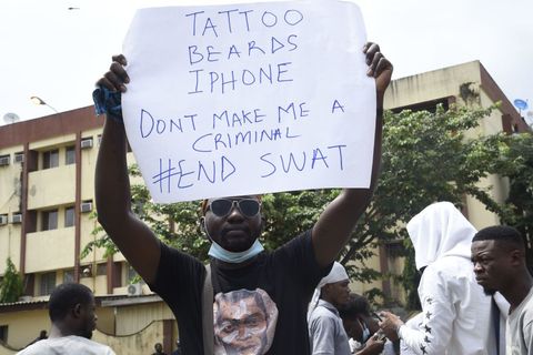 a protester holds a placard during a demonstration to campaign against police brutality and scrapping of the special anti robbery squad sars in lagos, on october 15, 2020   nigerian youth continued to march against police violence in several major cities across the country on october 15, 2020, despite further attacks on processions by men armed with sticks and machetes photo by pius utomi ekpei  afp photo by pius utomi ekpeiafp via getty images
