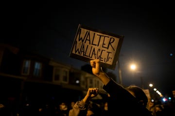 philadelphia, pa   october 27 demonstrators hold placards reading walter wallace jr during a protest near the location where walter wallace, jr was killed by two police officers on october 27, 2020 in philadelphia, pennsylvania protests erupted after the fatal shooting of 27 year old wallace jr, who philadelphia police officers claimed was armed with a knife photo by mark makelagetty images