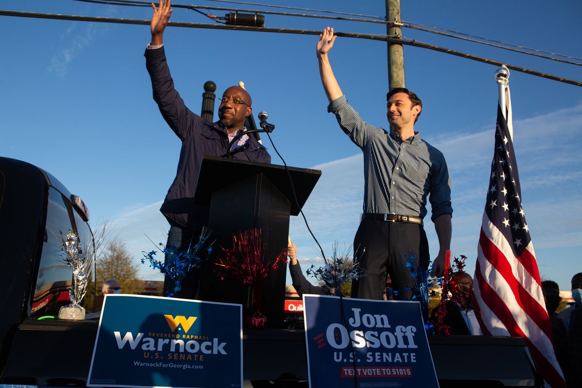 marietta, ga   november 15 democratic us senate candidates jon ossoff r and raphael warnock l of georgia wave to supporters during a rally on november 15, 2020 in marietta, georgia ossoff and warnock face incumbent us sens david purdue r ga and kelly loeffler r ga respectively in a runoff election january 5  photo by jessica mcgowangetty images