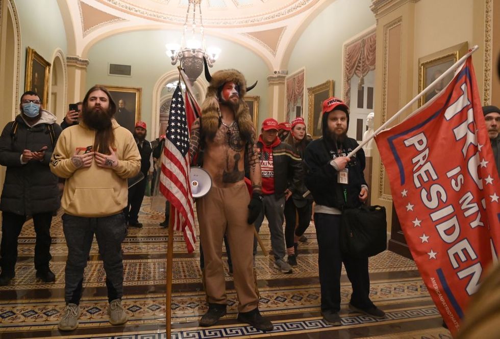 topshot   supporters of us president donald trump, including member of the qanon conspiracy group jake angeli, aka yellowstone wolf c, enter the us capitol on january 6, 2021, in washington, dc   demonstrators breeched security and entered the capitol as congress debated the a 2020 presidential election electoral vote certification photo by saul loeb  afp photo by saul loebafp via getty images