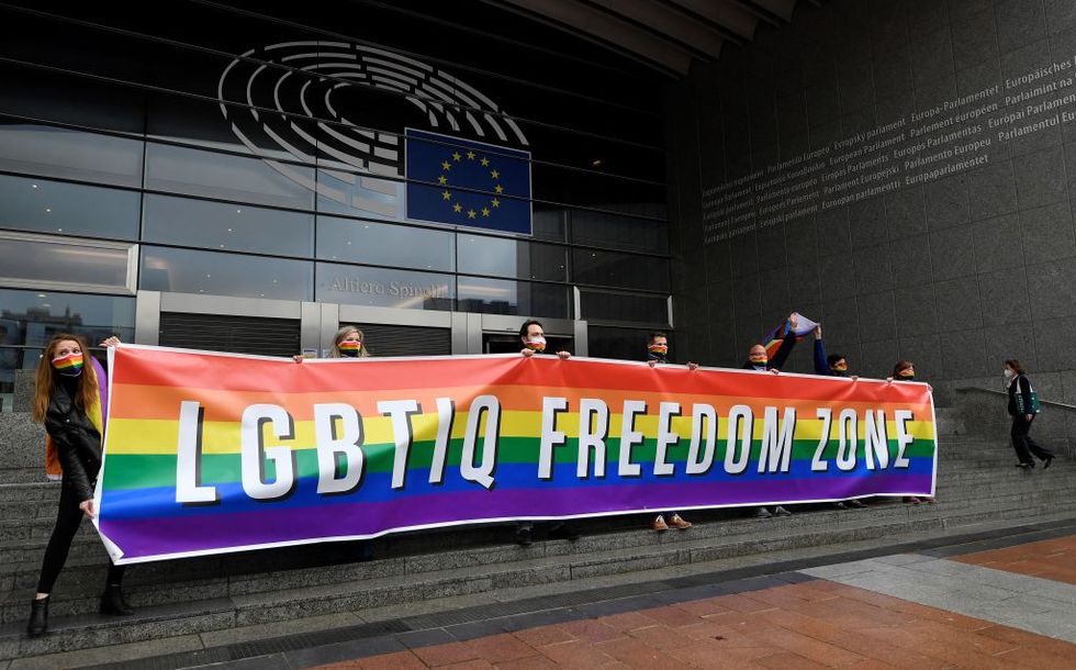 members of the european parliament roll out a banner to express their support for lgbtiq rights by calling for the eu to be an lgbtiq freedom zone as a vote takes place at the parliament on march 9, 2021   meps protest in response to the so called free of lgbt ideology zones that have been introduced by some local governments in poland, a move strongly condemned by the european parliament photo by john thys  afp photo by john thysafp via getty images