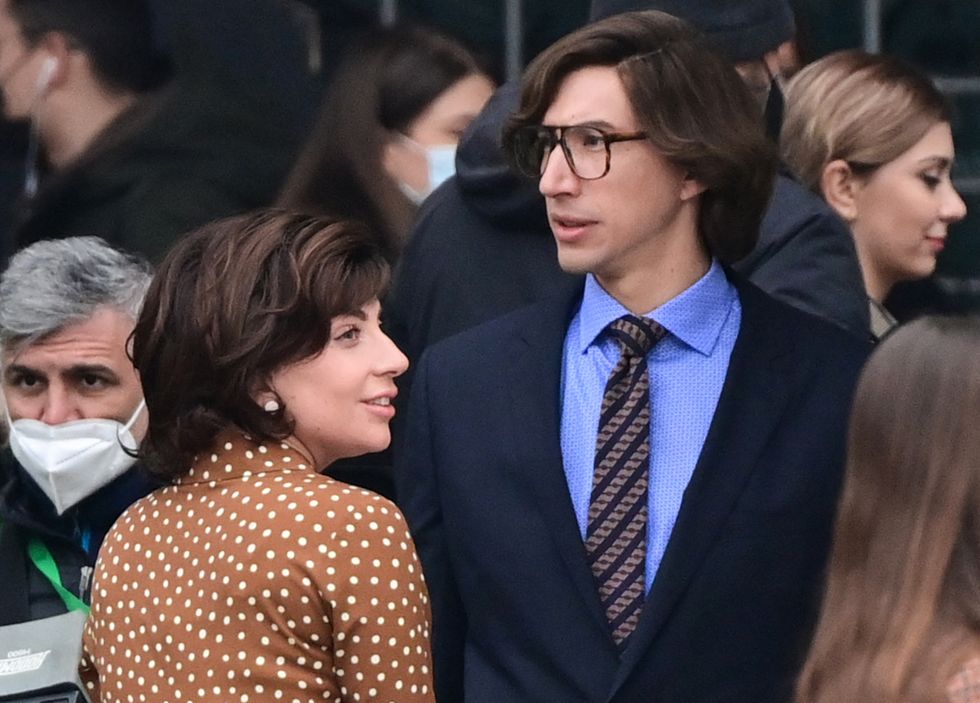 us singer, songwriter and actress lady gaga l and us actor adam driver r are pictured on march 11, 2021 on piazza duomo in central milan on the set of the new ridley scott movie about the gucci black widow patrizia reggiani, who was tried and convicted of orchestrating the assassination of her ex husband and former head of the gucci fashion house maurizio gucci   house of gucci, which stars lady gaga, adam driver, al pacino, jared leto, jack huston, reeve carney and jeremy irons, is an upcoming american biographical crime film directed by ridley scott, scheduled to be released in the united states on november 24, 2021 by metro goldwyn mayer photo by miguel medina  afp photo by miguel medinaafp via getty images