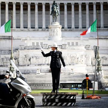 female municipal police traffic officer, cristina corbucci directs traffic on the historic platform on piazza venezia in central rome on march 26, 2021 amid restrictions of the covid 19 coronavirus pandemic   corbucci is the first woman to climb the historic platform of piazza venezia, after the new commander of rome's local police decided to break with the all male tradition photo by alberto pizzoli  afp photo by alberto pizzoliafp via getty images