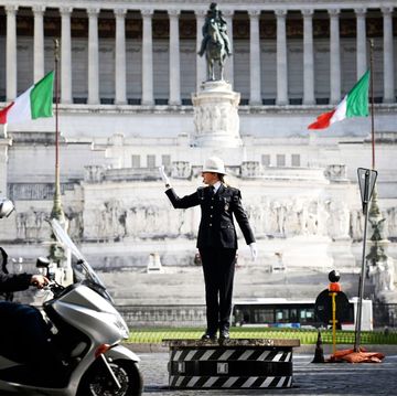 female municipal police traffic officer, cristina corbucci directs traffic on the historic platform on piazza venezia in central rome on march 26, 2021 amid restrictions of the covid 19 coronavirus pandemic   corbucci is the first woman to climb the historic platform of piazza venezia, after the new commander of rome's local police decided to break with the all male tradition photo by alberto pizzoli  afp photo by alberto pizzoliafp via getty images
