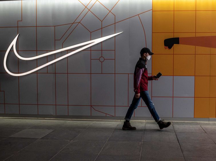 a man walks past a nike store in beijing on april 5, 2021 photo by nicolas asfouri  afp photo by nicolas asfouriafp via getty images