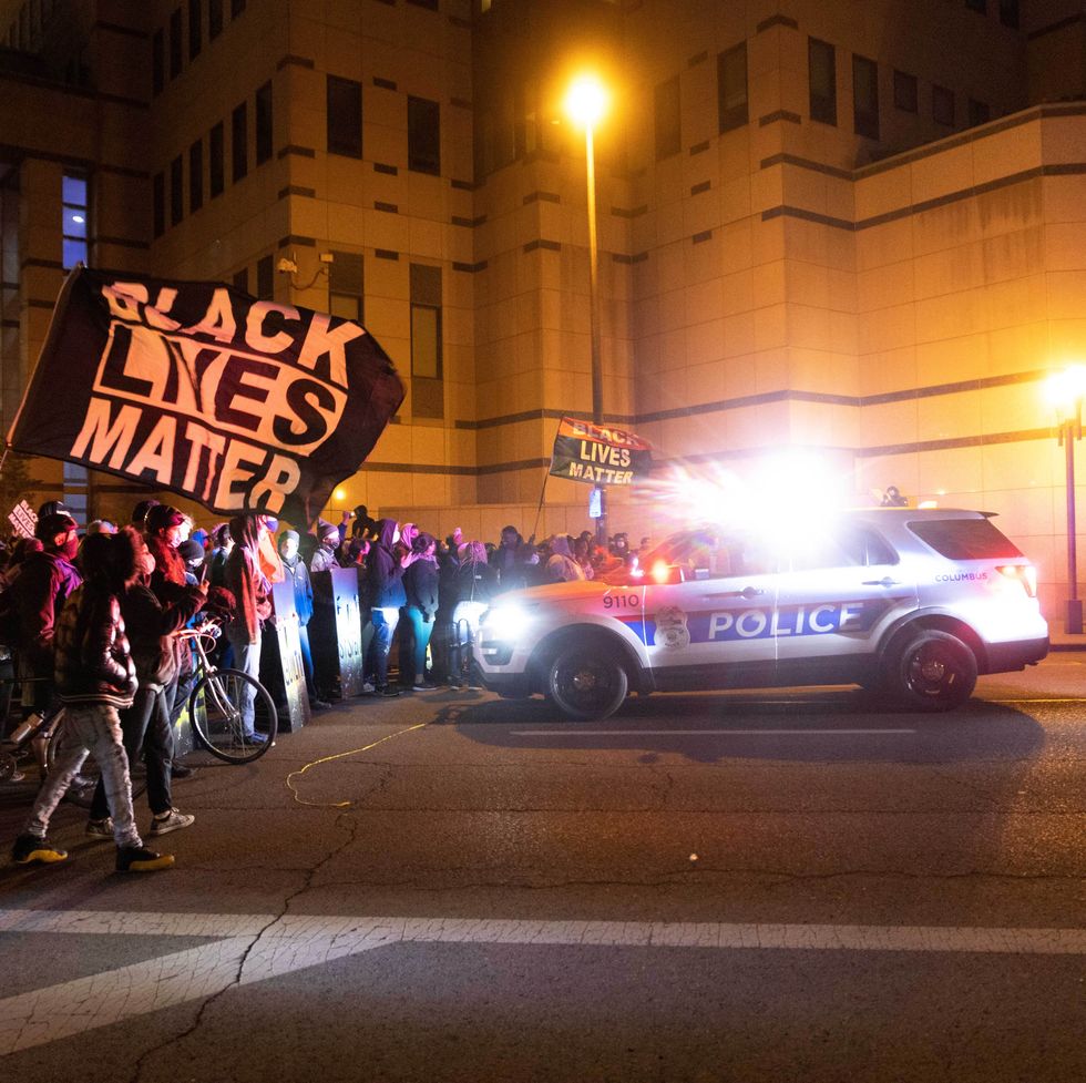 protestors approach a columbus cop car at night