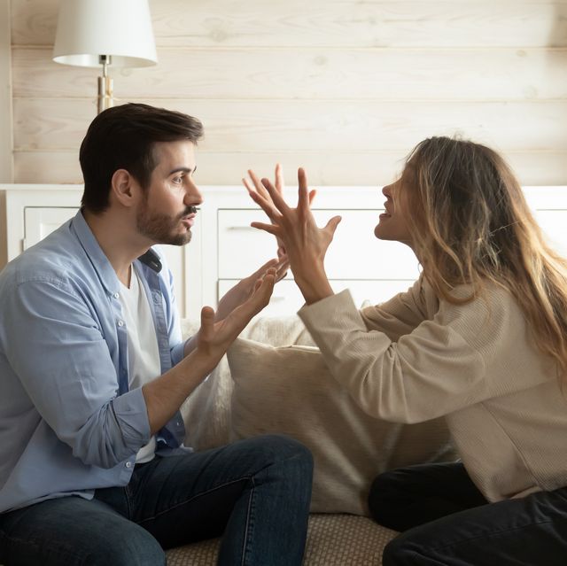 emotional annoyed stressed couple sitting on couch, arguing at home angry irritated nervous woman man shouting at each other, figuring out relations, feeling outraged, relationship problems concept
