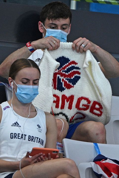 british diver thomas daley sits with his knitting as he watches divers in the preliminary round of the mens 3m springboard diving event during the tokyo 2020 olympic games at the tokyo aquatics centre in tokyo on august 2, 2021 photo by oli scarff  afp photo by oli scarffafp via getty images