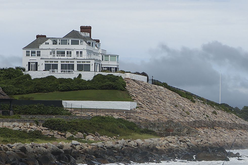westerly, ri august 22 a man fishes at the watch hill lighthouse for stripped bass with home of taylor swift in the background during the eye of the tropical storm henri in westerly, ri on aug 22, 2021 photo by matthew j leethe boston globe via getty images