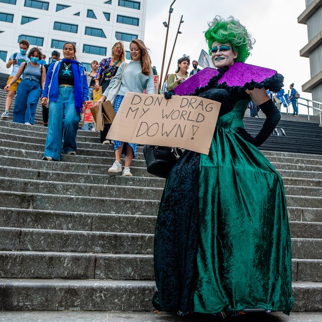 a drag queen is walking down the stairs with a placard in support of the climate, during the global climate strike organized in utrecht, on september 24th, 2021 photo by romy arroyo fernandeznurphoto
