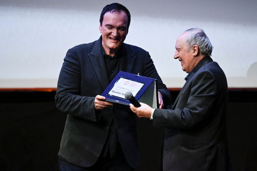 us director quentin tarantino l acknowledges receiving from italian director dario argento a lifetime achievement award during a ceremony on october 19, 2021 at the auditorium parco della musica venue in rome, during the 16th rome film festival photo by alberto pizzoli  afp photo by alberto pizzoliafp via getty images