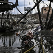 TOPSHOT-UKRAINE-RUSSIA-CONFLICT abandoned strollers are pictured under a destroyed bridge as people flee the city of irpin, west of kyiv, on march 7, 2022 russian forces pummelled ukrainian cities from the air, land and sea on monday, with warnings they were preparing for an assault on the capital kyiv, as terrified civilians failed for a second day to escape besieged mariupol