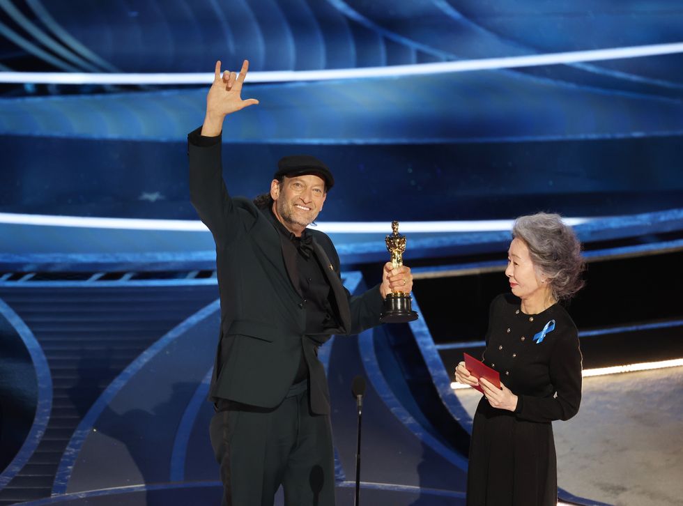 hollywood, ca   march 27, 2022    troy kotsur accepts the actor in a supporting role award for coda from youn yuh jung  during the show  at the 94th academy awards at the dolby theatre at ovation hollywood on sunday, march 27, 2022  myung chun  los angeles times via getty images