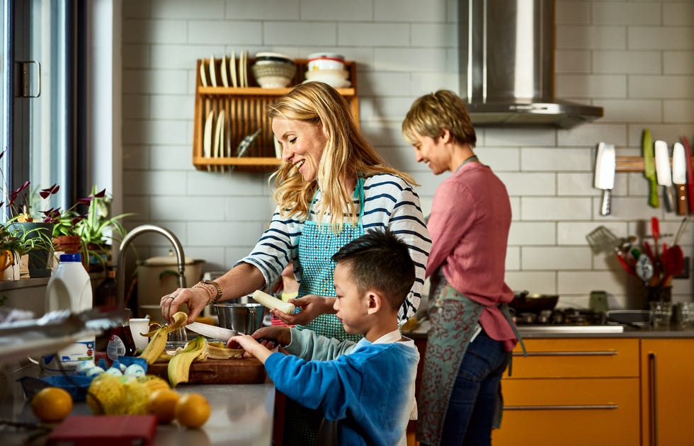 parents cooking with child in kitchen