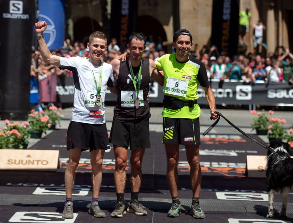 (from l) second placed italian ultra trailer davide magnini, winner spanish ultra trailer kilian jornet and third placed spanish ultra trailer manuel marillas celebrate after the xxi zegama aizkorri mendi maratoia ultra trail competition on may 29, 2022, in zegama. jornet beat the record of the alpine trail running event that scores for the golden trail world series 2022. (photo by ander gillenea / afp) (photo by ander gillenea/afp via getty images)