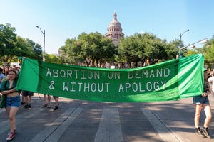 a protest banner that reads abortion on demand and without apology