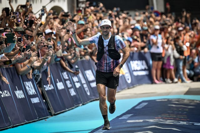 spains kilian jornet celebrates as he crosses the finish line and wins the 19th edition of the ultra trail du mont blanc utmb a 171km trail race crossing france, italy and switzerland in chamonix, south eastern france on august 27, 2022