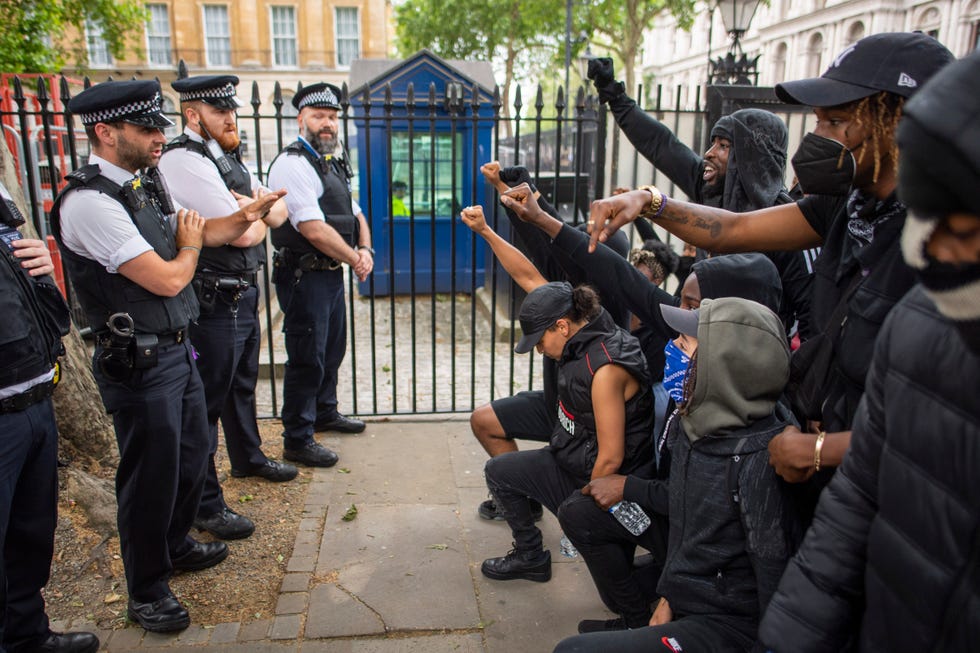 london, england   june 03 people kneel in front of police during a black lives matter protest at hyde park on june 03, 2020 in london, england  the death of an african american man, george floyd, while in the custody of minneapolis police has sparked protests across the united states, as well as demonstrations of solidarity in many countries around the world photo by justin setterfieldgetty images