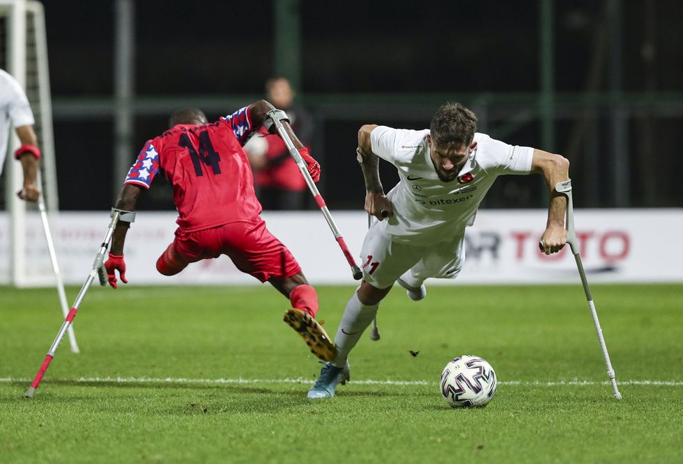 Omer Guleryuz van Turkije neemt het op tegen de Liberiaanse speler Jusu Mohamed Delvin tijdens een wedstrijd in Istanboel