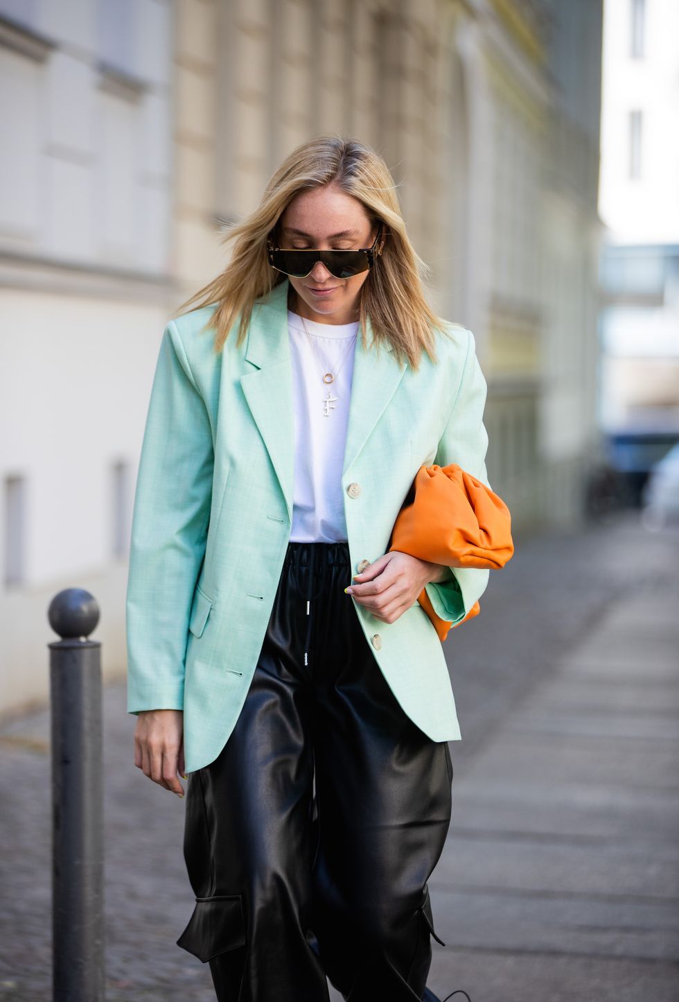 berlin, germany   june 03 sonia lyson is seen wearing black pants and white tshirt the frankie shop, mint blazer other stories, orange pouch bag bottega veneta, linda farrow sunglasses on june 03, 2020 in berlin, germany photo by christian vieriggetty images