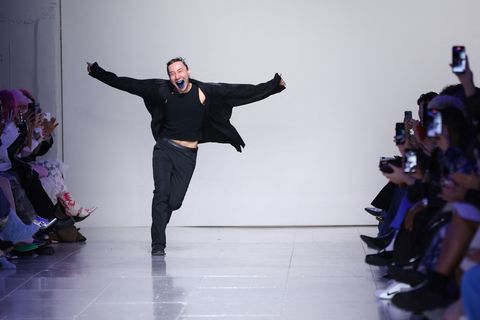 designer chet lo runs down a london fashion week catwalk showing off his blue tongue