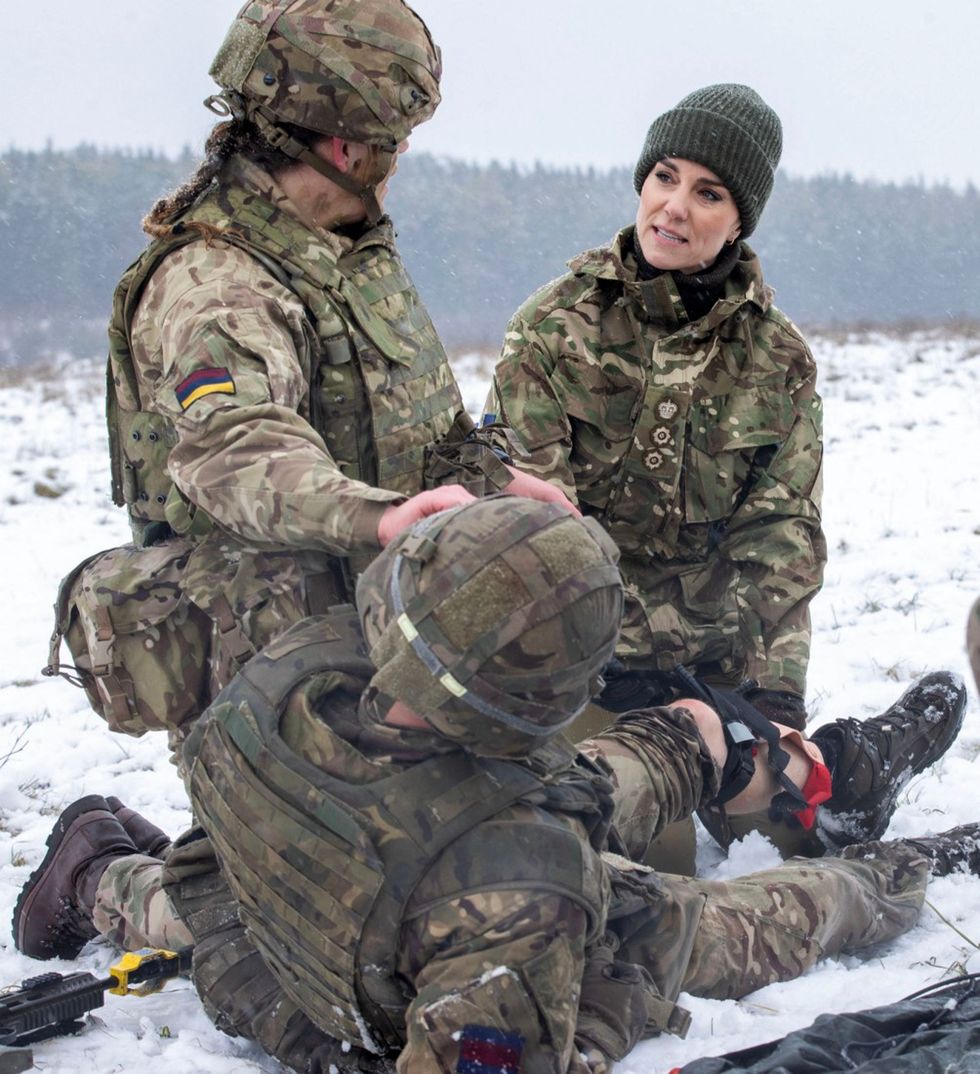britains catherine, princess of wales r is given instructions by lance corporal jodie newell l as she battlefield casualty drills to deliver care to injured soldiers during a casualty simulation, during her visit to 1st battalion irish guards on a training exercise at the salisbury plain training area, near salisbury, southern england, on march 8, 2023 photo by steve reigate pool afp photo by steve reigatepoolafp via getty images