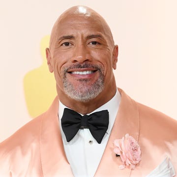 dwayne johnson at a film premiere wearing a pink tuxedo