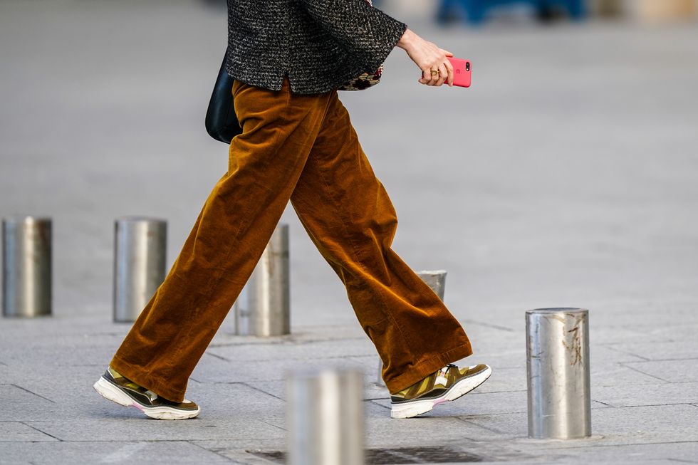 paris, france   june 08 a passerby wears brown corduroy flared pants, sneakers shoes, on june 08, 2020 in paris, france photo by edward berthelotgetty images