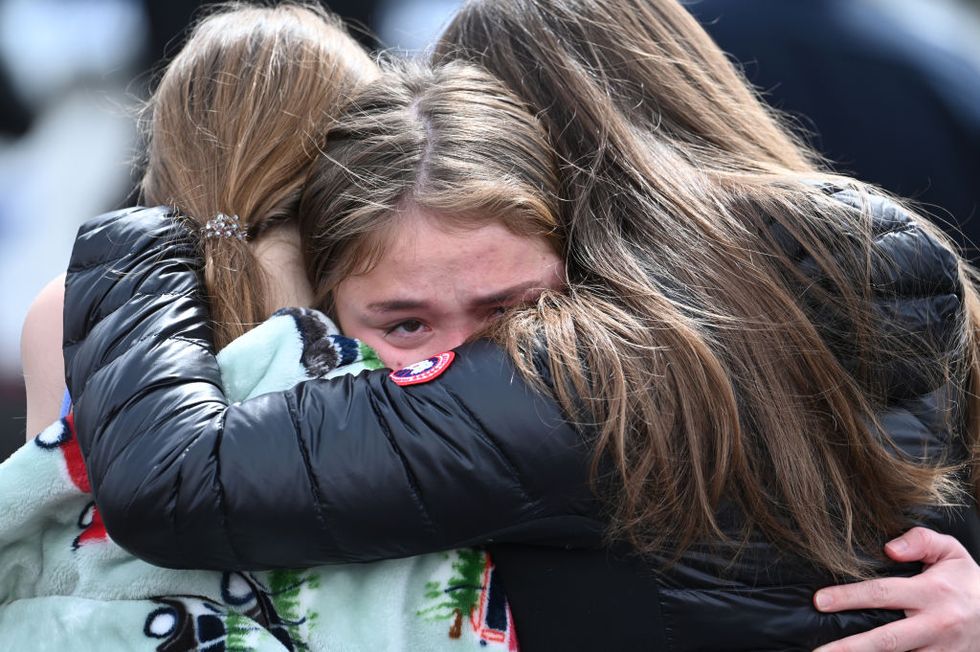 denver, co march 22 denver east high school students clara little, 17, left, rowan hillhouse, 18, center, and sofia smith, 18, embrace after leaving the school after a shooting there on wednesday, march 22, 2023 police said a student shot two adult male faculty members, and that a known suspect had left the school photo by hyoung changthe denver post