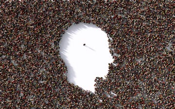 single man standing inside of a human head shape which is formed by human crowd