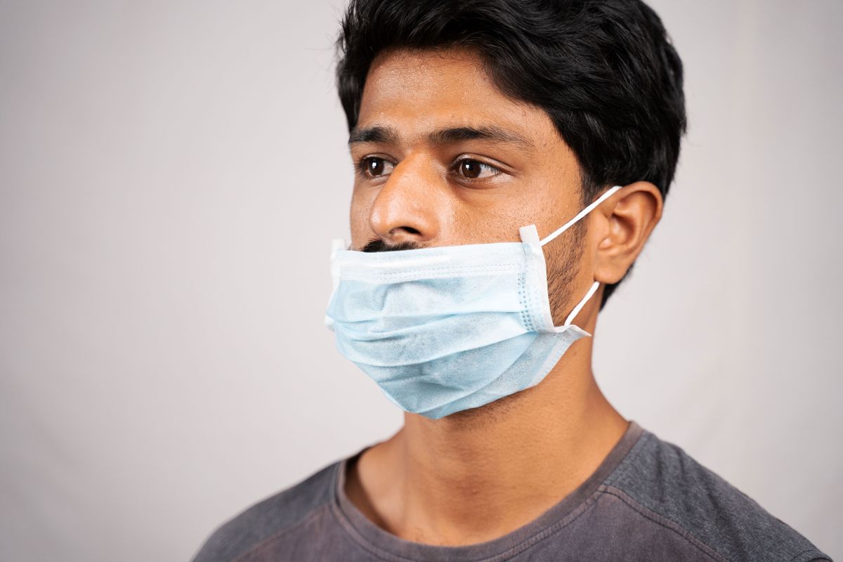 man wearing mask over mouth but not nose
