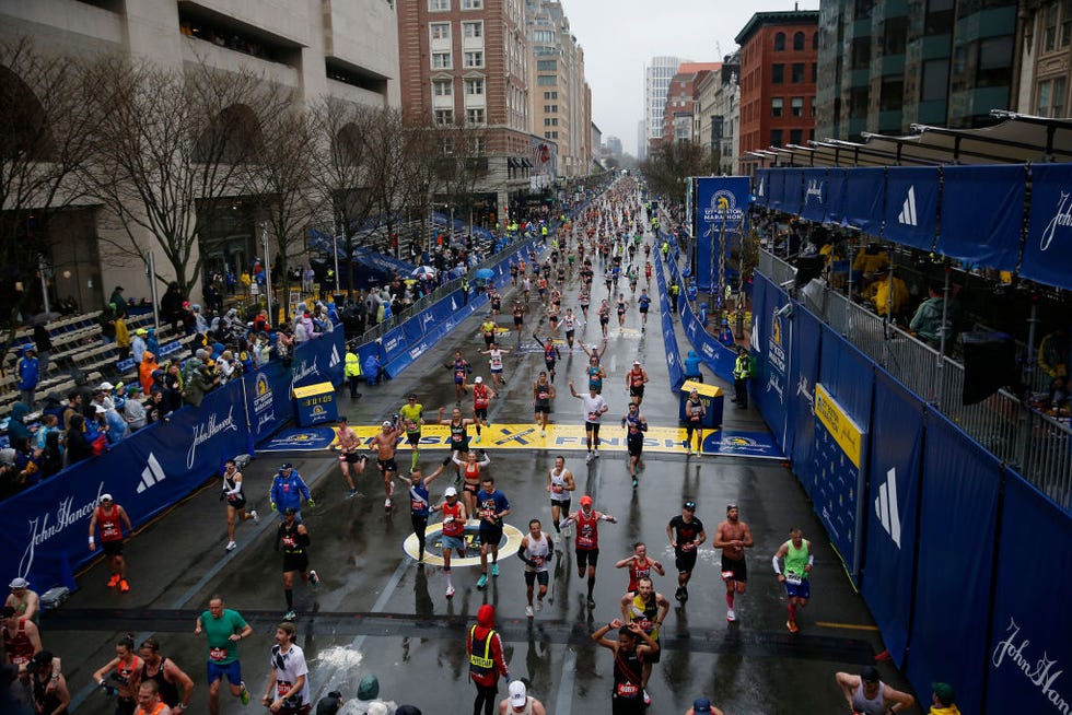 boston, ma april 17 runners stream down boylston street as rain falls on the 127th boston marathon photo by jessica rinaldithe boston globe via getty images