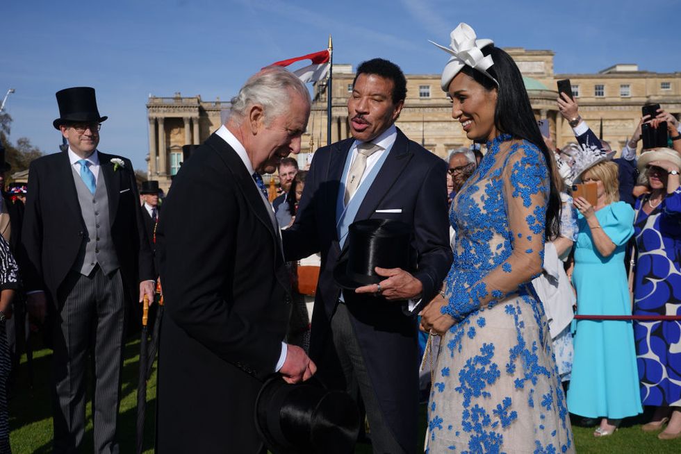 london, england may 03 king charles iii speaks with lionel richie and lisa parigi during the garden party at buckingham palace ahead of the coronation of the king charles iii and the queen consort at buckingham palace, on may 3, 2023 in london, england photo by yui mok wpa poolgetty images