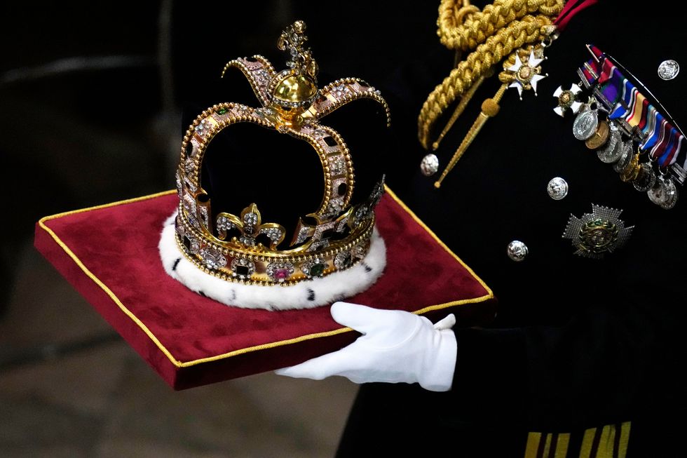 17th century st edwards crown is carried at westminster abbey in central london on may 6, 2023, ahead of the coronations of britains king charles iii and britains camilla, queen consort the set piece coronation is the first in britain in 70 years, and only the second in history to be televised charles will be the 40th reigning monarch to be crowned at the central london church since king william i in 1066 outside the uk, he is also king of 14 other commonwealth countries, including australia, canada and new zealand camilla, his second wife, will be crowned queen alongside him, and be known as queen camilla after the ceremony photo by kirsty wigglesworth pool afp photo by kirsty wigglesworthpoolafp via getty images