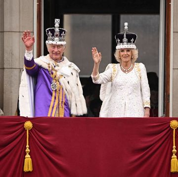 topshot britains king charles iii wearing the imperial state crown, and britains queen camilla wearing a modified version of queen marys crown wave from the buckingham palace balcony after viewing the royal air force fly past in central london on may 6, 2023, after their coronations the set piece coronation is the first in britain in 70 years, and only the second in history to be televised charles will be the 40th reigning monarch to be crowned at the central london church since king william i in 1066 photo by oli scarff afp photo by oli scarffafp via getty images