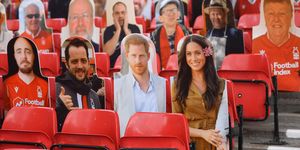 nottingham, england   june 28 harry and meghan the duke and duchess of sussex look out amongst the cardboard fans profile pictures in the main stand ahead of the sky bet championship match between nottingham forest and huddersfield town at city ground on june 28, 2020 in nottingham, england photo by laurence griffithsgetty images