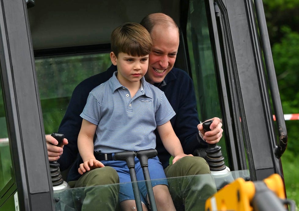 london, england may 08: prince william, prince of wales is helped by prince louis of wales (l) as he uses an excavator while taking part in the big help out, during a visit to the 3rd upton scouts hut on may 8, 2023 in london, england. the big help out is a day when people are encouraged to volunteer in their communities. it is part of the celebrations of the coronation of charles iii and his wife, camilla, as king and queen of the united kingdom of great britain and northern ireland, and the other commonwealth realms that took place at westminster abbey on saturday, may 6, 2023. (photo by daniel leal wpa pool/getty images)