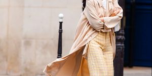 paris, france   july 04 a passerby wears yellow checked wool knitted pants, a salmon pink flowing long coat, on july 04, 2020 in paris, france photo by edward berthelotgetty images