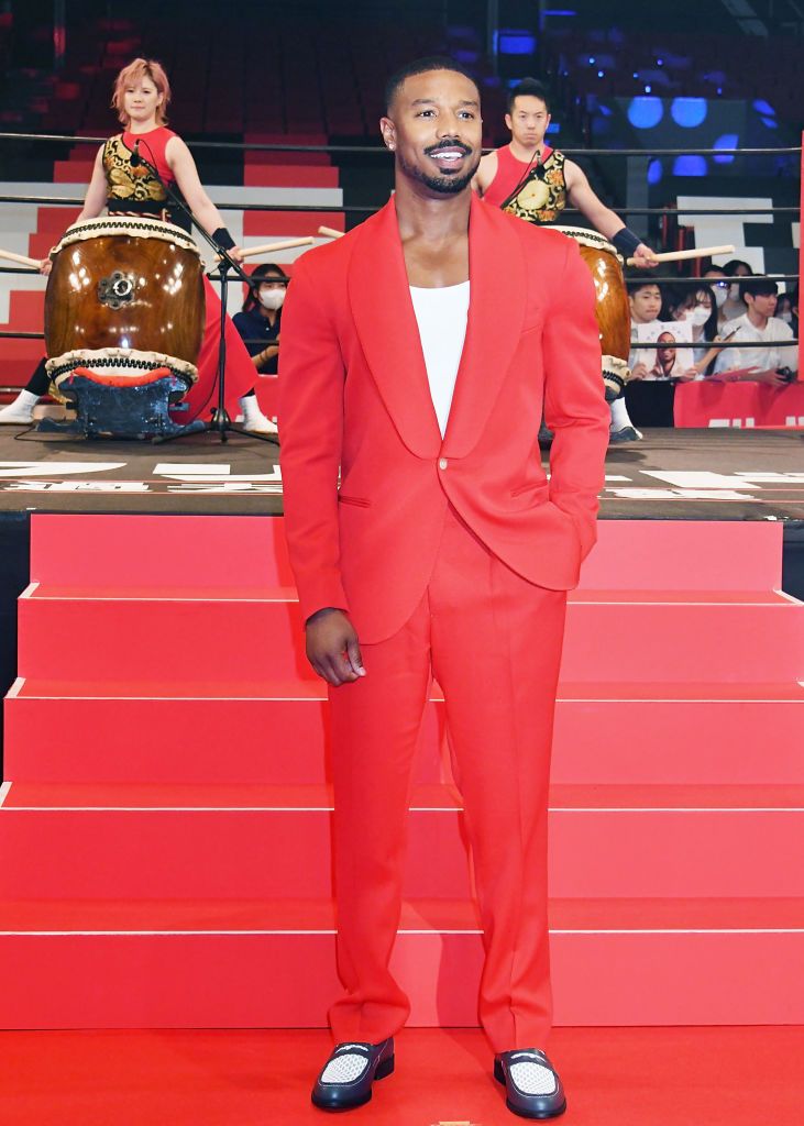 Lexica - Man wearing a red suit jacket with a blue shirt