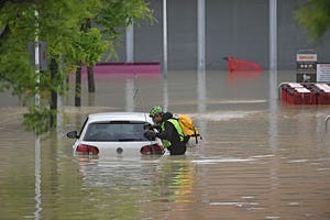 a speleological alpine rescuer looks in a car for missing persons near a supermarket in a flooded area in cesena on may 17, 2023 heavy rains have caused major floodings in central italy, where trains were stopped and schools were closed in many towns while people were asked to leave the ground floors of their homes and to avoid going out five people have died after the floodings across italys northern emilia romagna region, a local official said photo by alessandro serrano afp photo by alessandro serranoafp via getty images