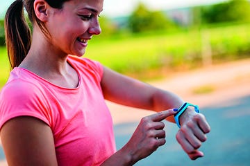 active and healthy woman checking fitness activity on the smartwatch after workout.