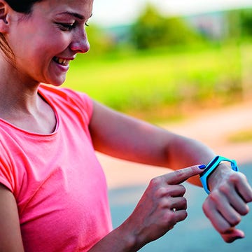Woman checking pulse on the smartwatch active and healthy woman checking fitness activity on the smartwatch after workout.