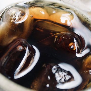 the creative photo of ice cubes in coca cola