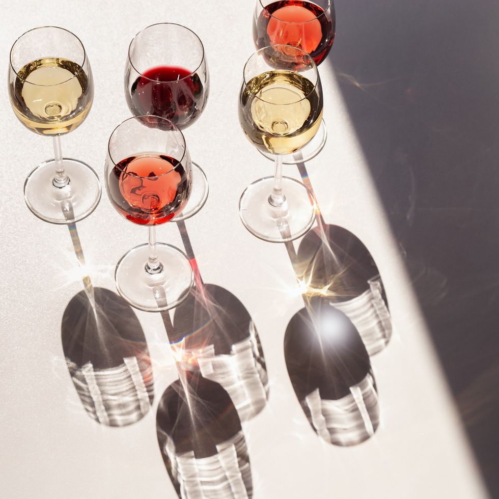 set of wine in glasses red, rose and white wine  hard light view from above