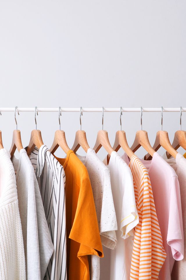 fashion clothes on a rack in a light background indoors place for text