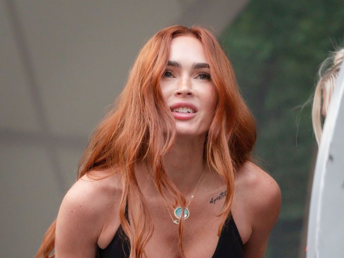 Megan Fox Wears a Plunging Bodysuit Tucked Underneath Lacy Tights