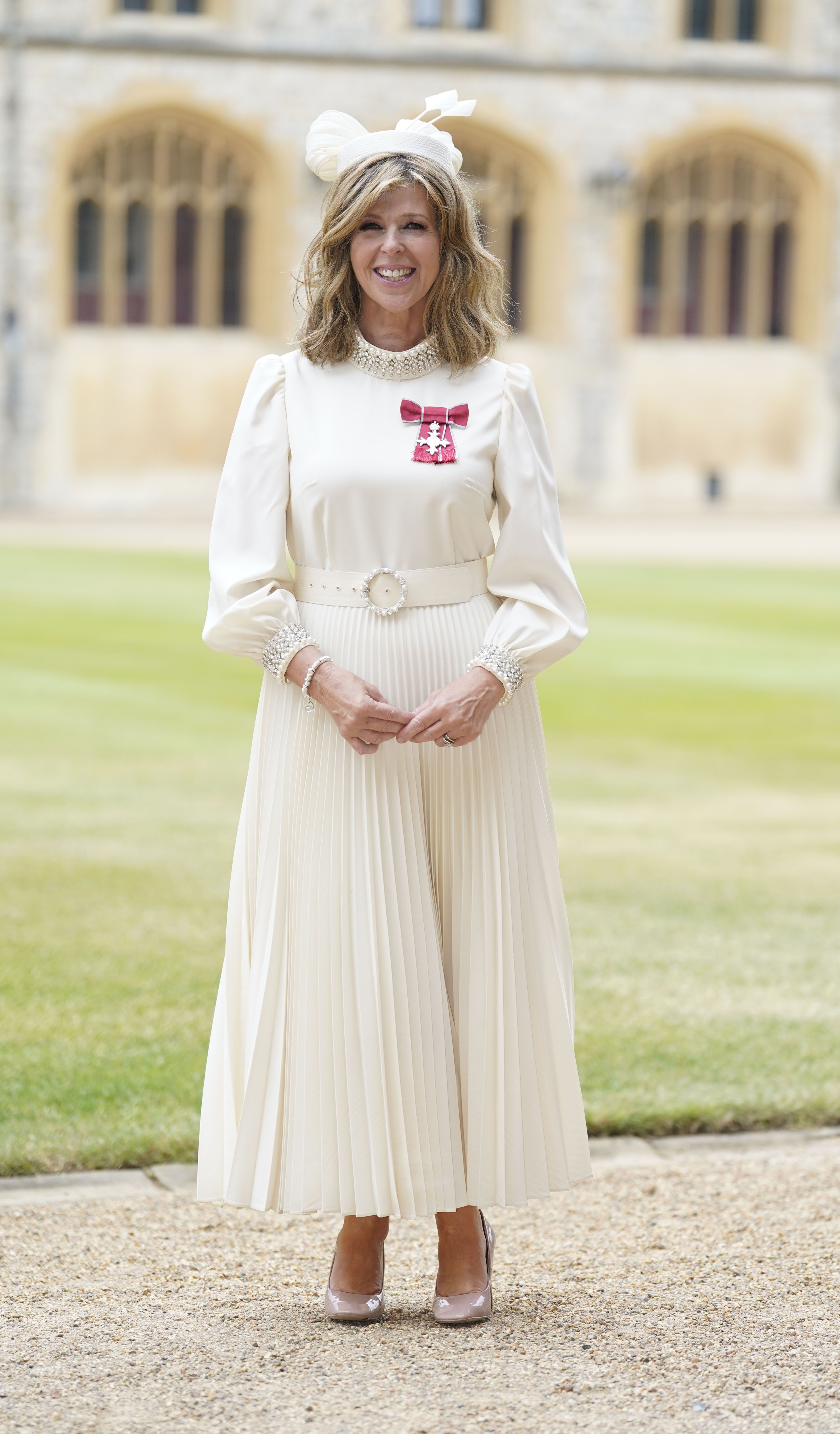 Kate Garraway opts for a white dress to receive her royal honour